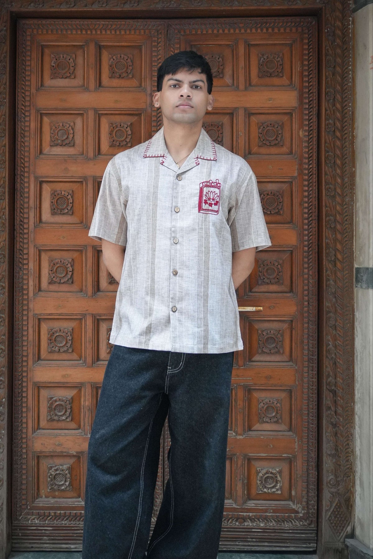 Sand beige cotton shirt for men with hand embroidered matchbox motif, full-length view