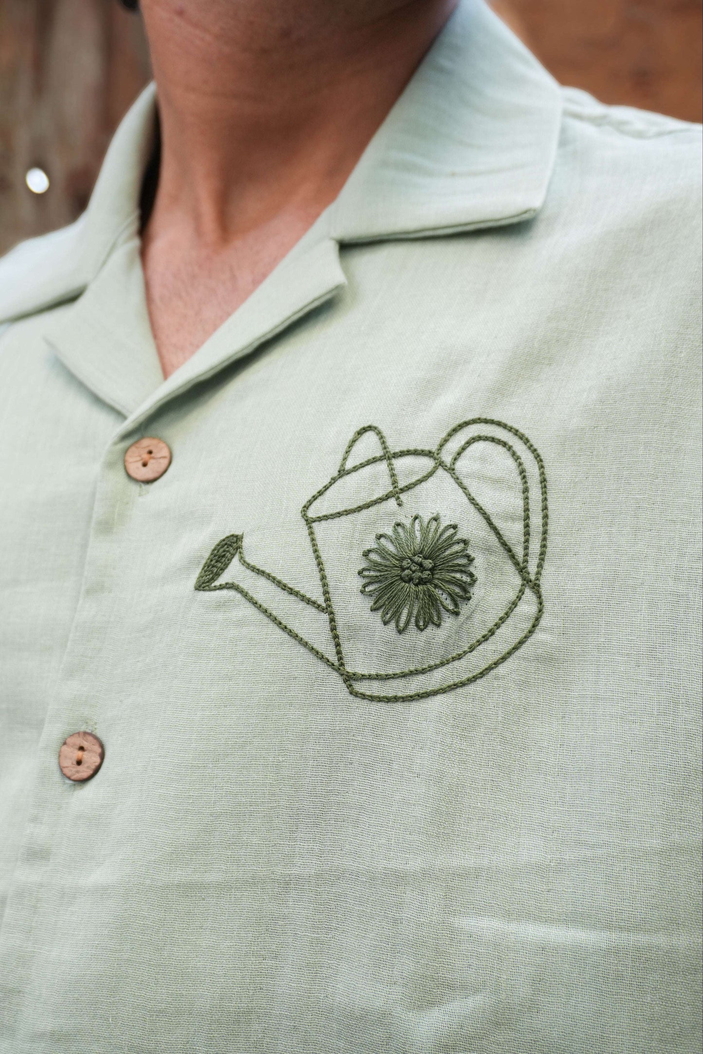 Close-up of the watering can motif on the chest, Sage green double cloth cotton men's shirt