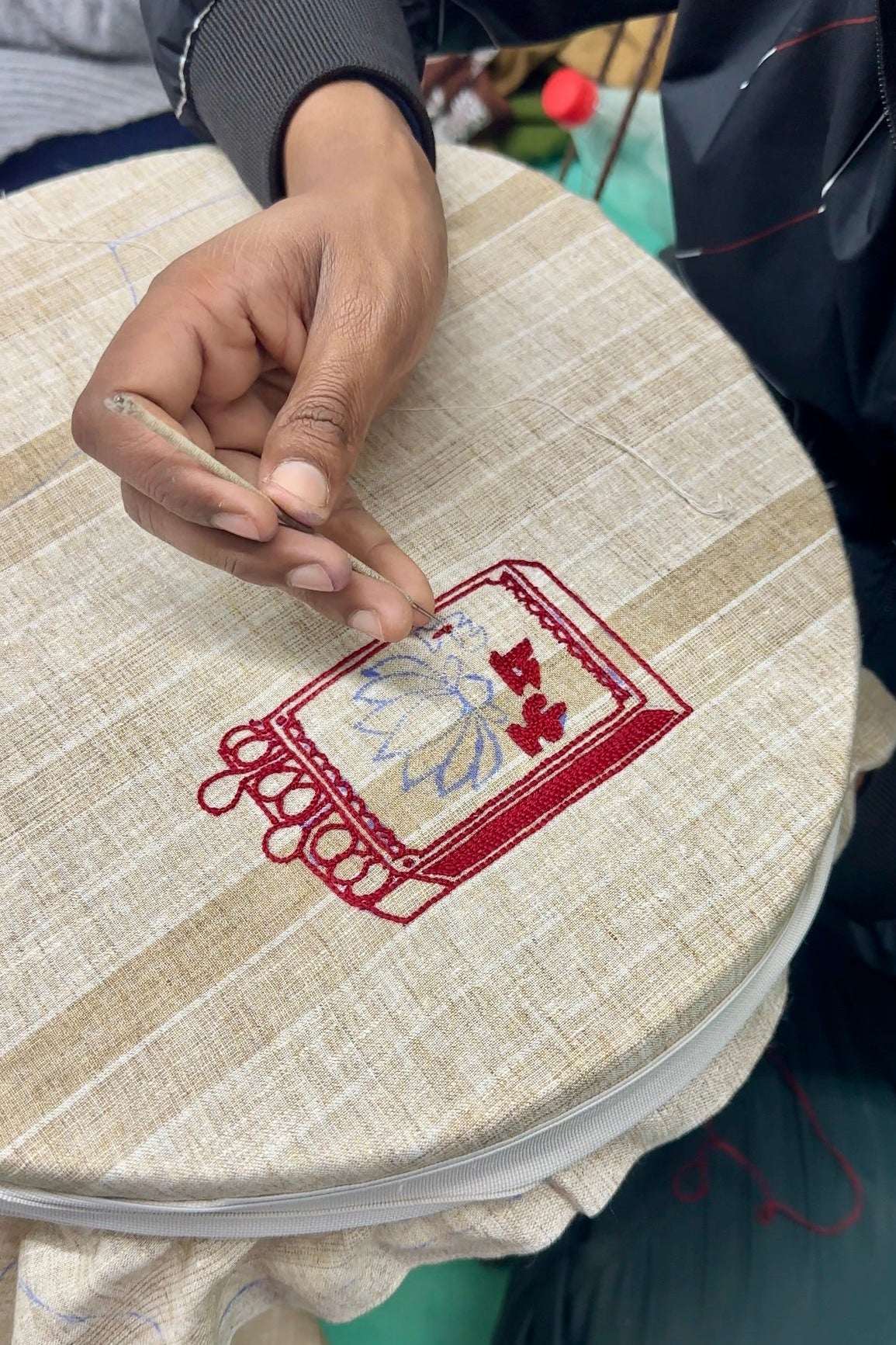Artisan hand embroidering the matchbox motif, the making of the Sivakasi Embroidered Shirt by Oje'