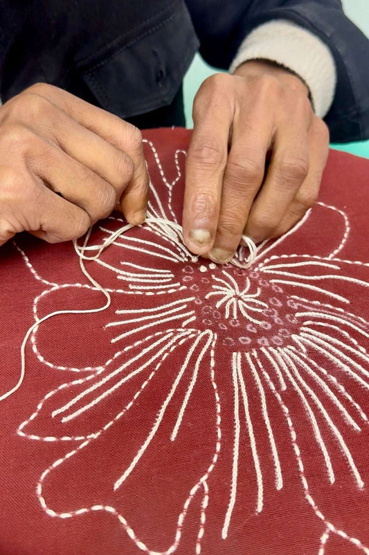 Artisan hand embroidering French knot florals, the making of the Nainital Embroidered Shirt by Oje'