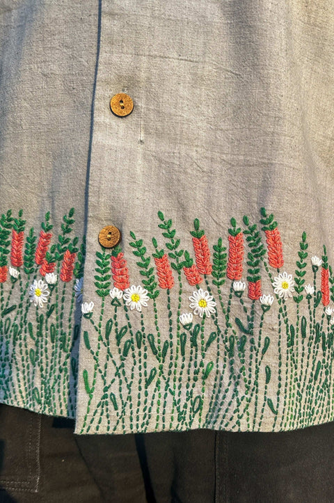 Close-up of the floral meadow embroidery on the hem, Pearl grey handloom cotton men's shirt