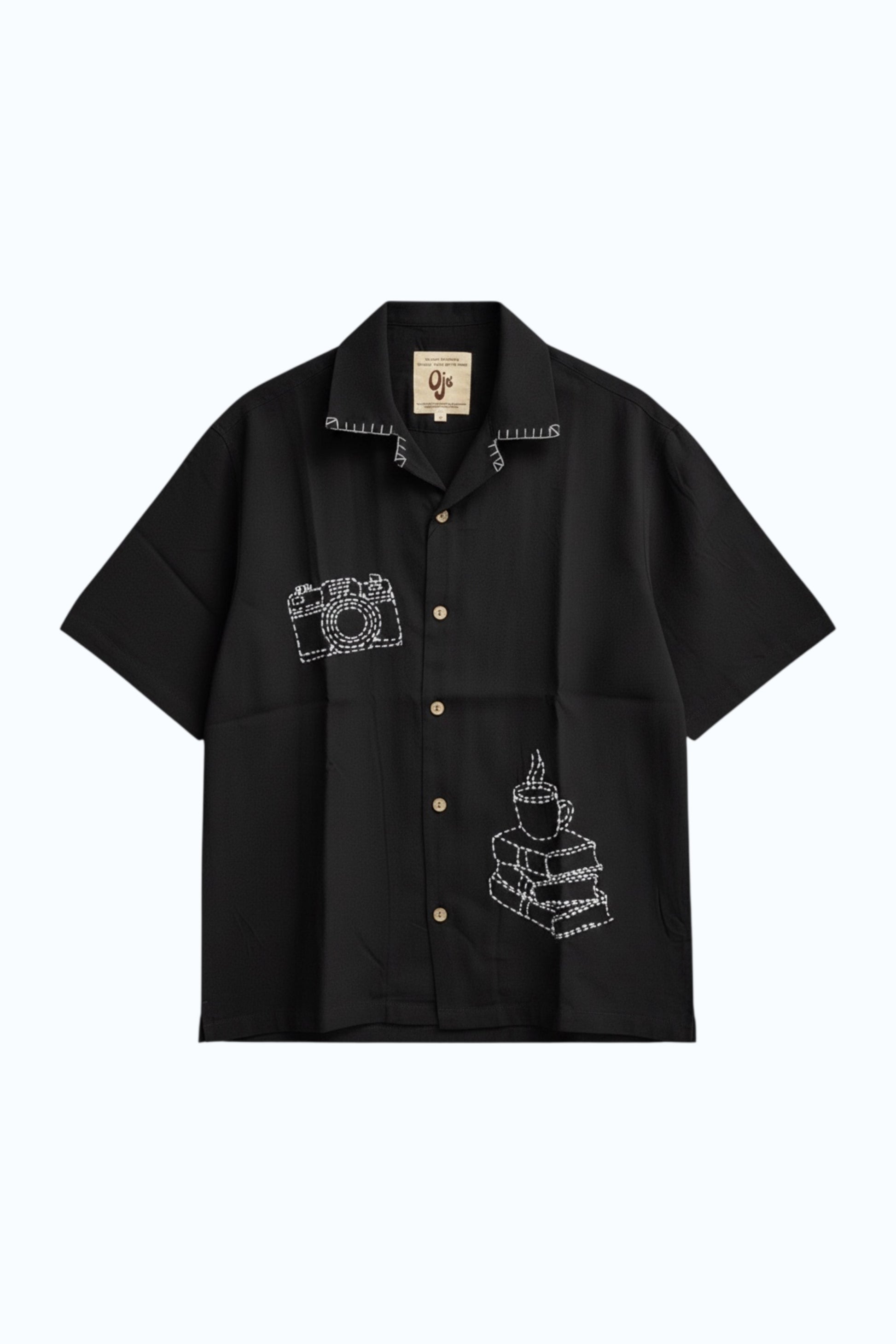 Black modal shirt with hand embroidered camera and coffee motifs, flat lay