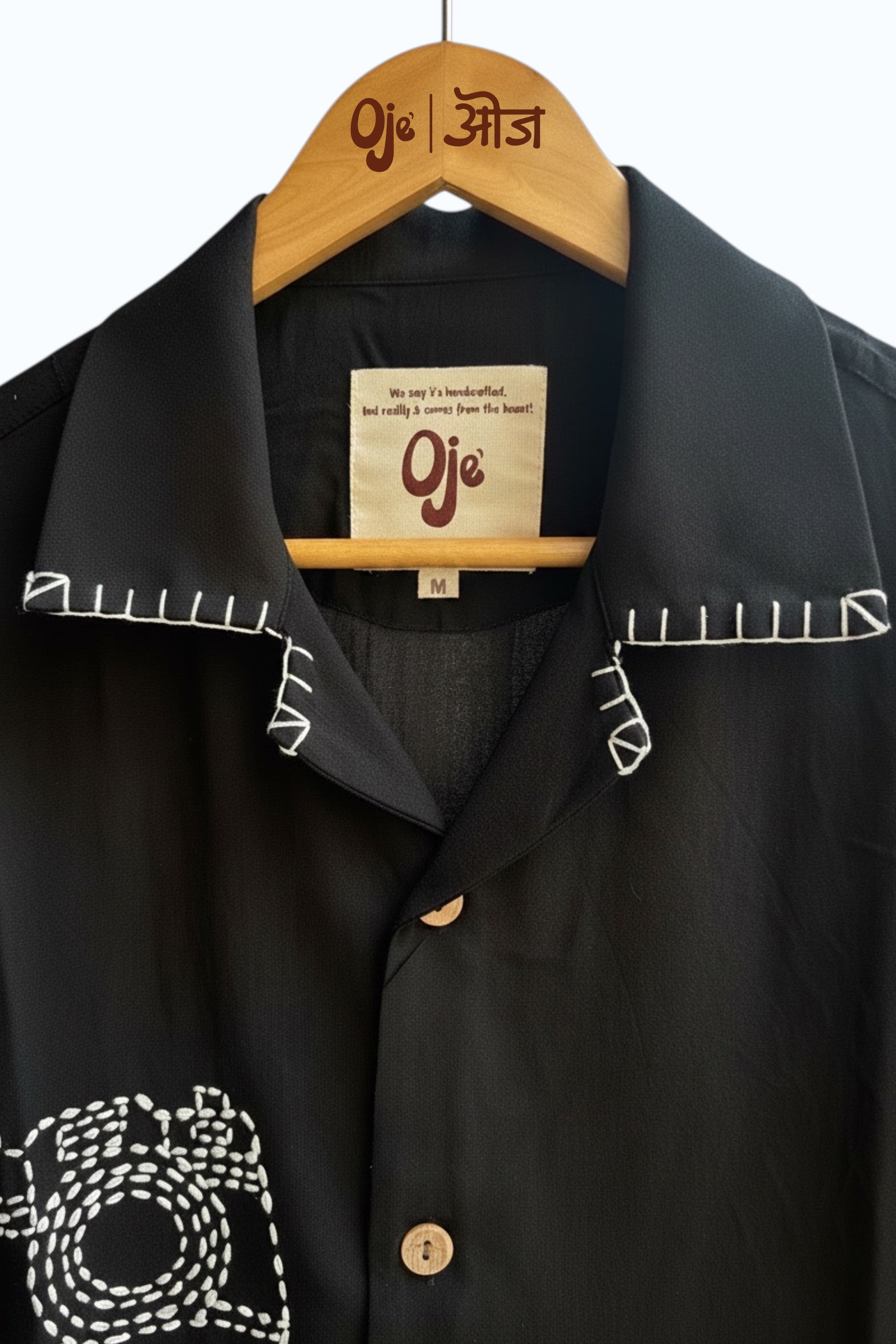 Black Vienna shirt on hanger showing collar embroidery