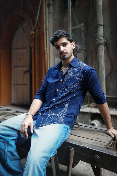 Navy blue cotton shirt for men with kantha hand embroidered motifs, seated view, Ziro Embroidered Shirt by Oje'