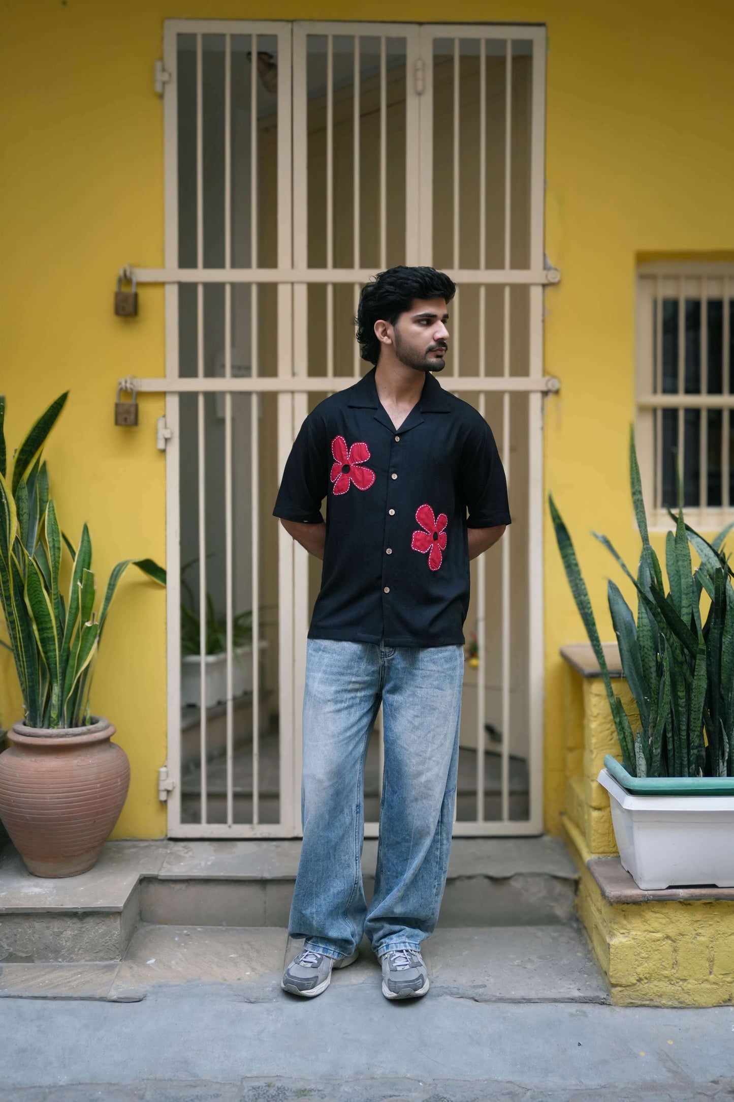 Black modal viscose shirt for men with hand appliquéd red floral motifs, full-length view