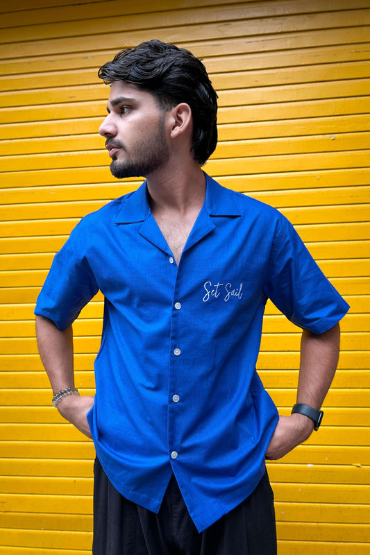 Cobalt blue cotton shirt for men with appliquéd sailboat on the back, front view