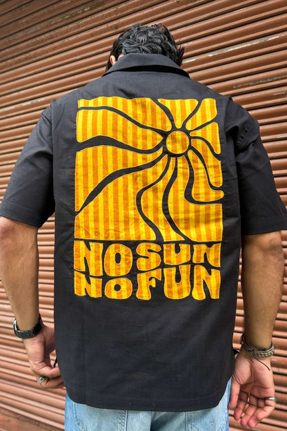 Close-up of the appliquéd sun and lettering on the back, Black cotton men's shirt