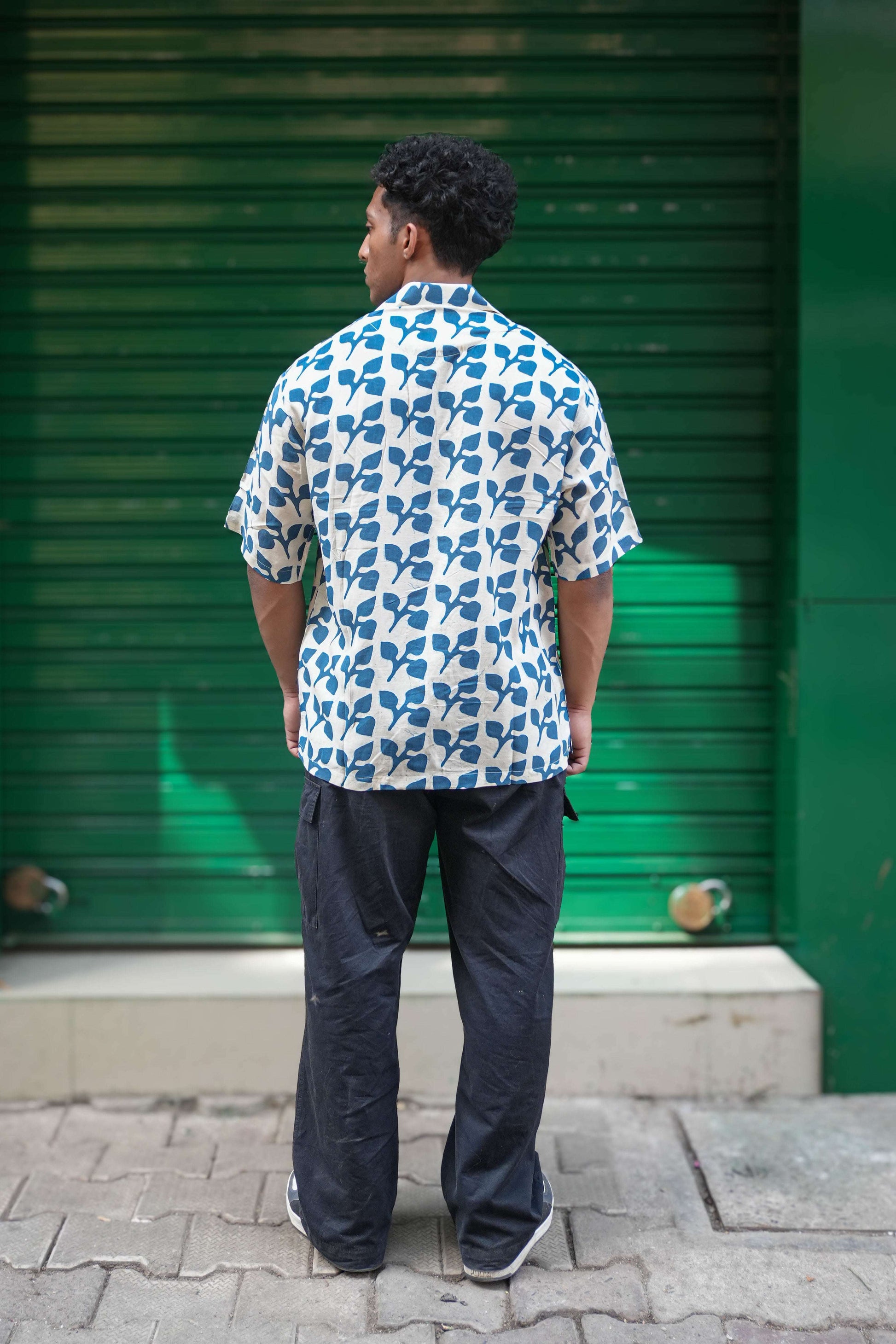 Back view of Indigo blue printed viscose men's shirt showing the relaxed drape