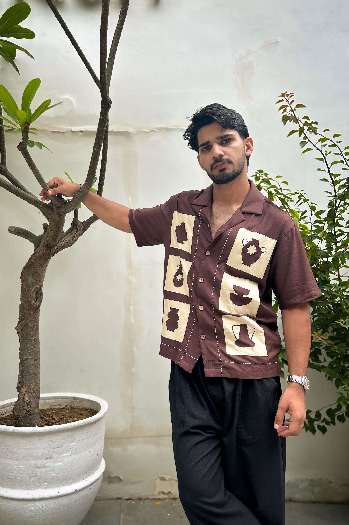 Brown modal shirt for men with pottery appliqué motifs, three-quarter view