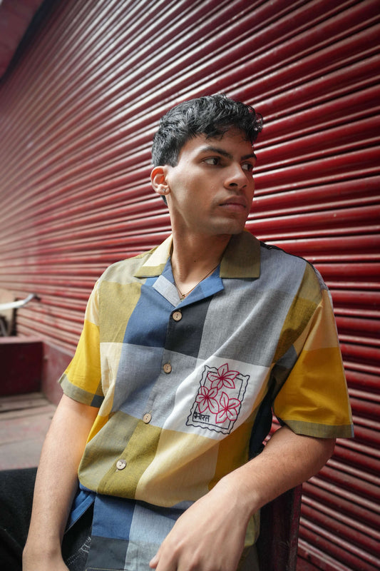 Multicolour checks cotton shirt for men with hand embroidered stamp motif, seated three-quarter view