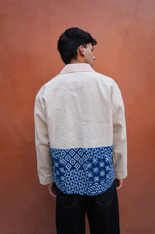 Back view of White and indigo cotton men's jacket showing the relaxed drape