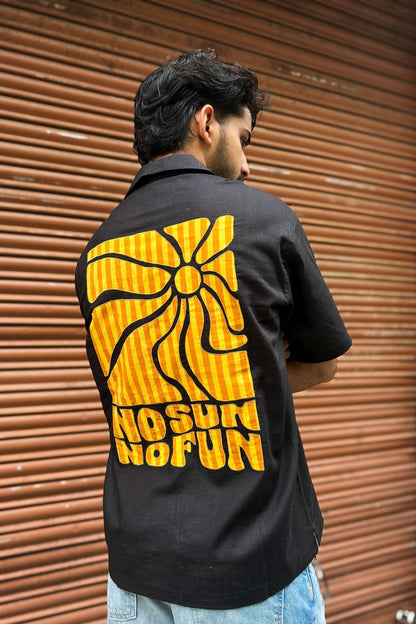 Black cotton shirt for men with appliquéd sun motif on the back, back three-quarter view