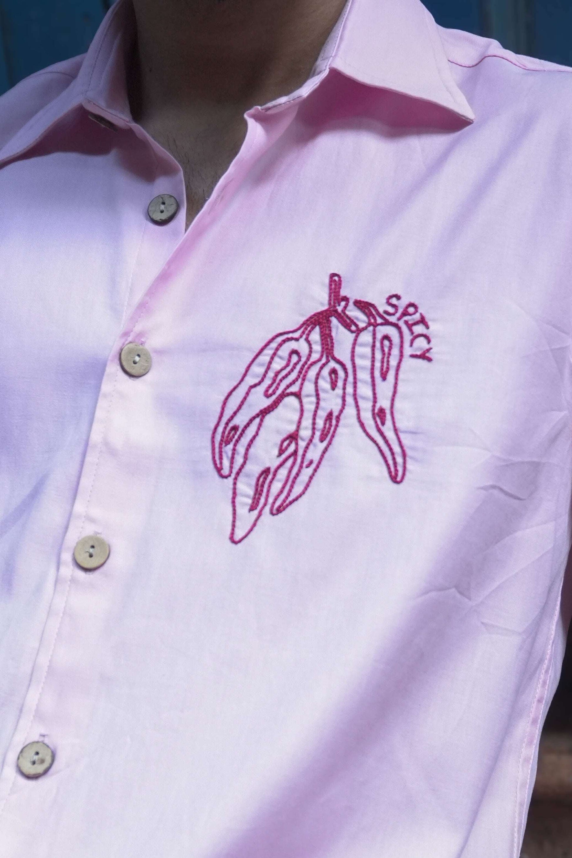 Close-up of the chilli motif with embroidered text, Blush pink cotton satin men's shirt