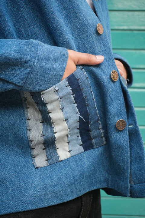 Close-up of the kantha patchwork pocket, Blue denim men's jacket