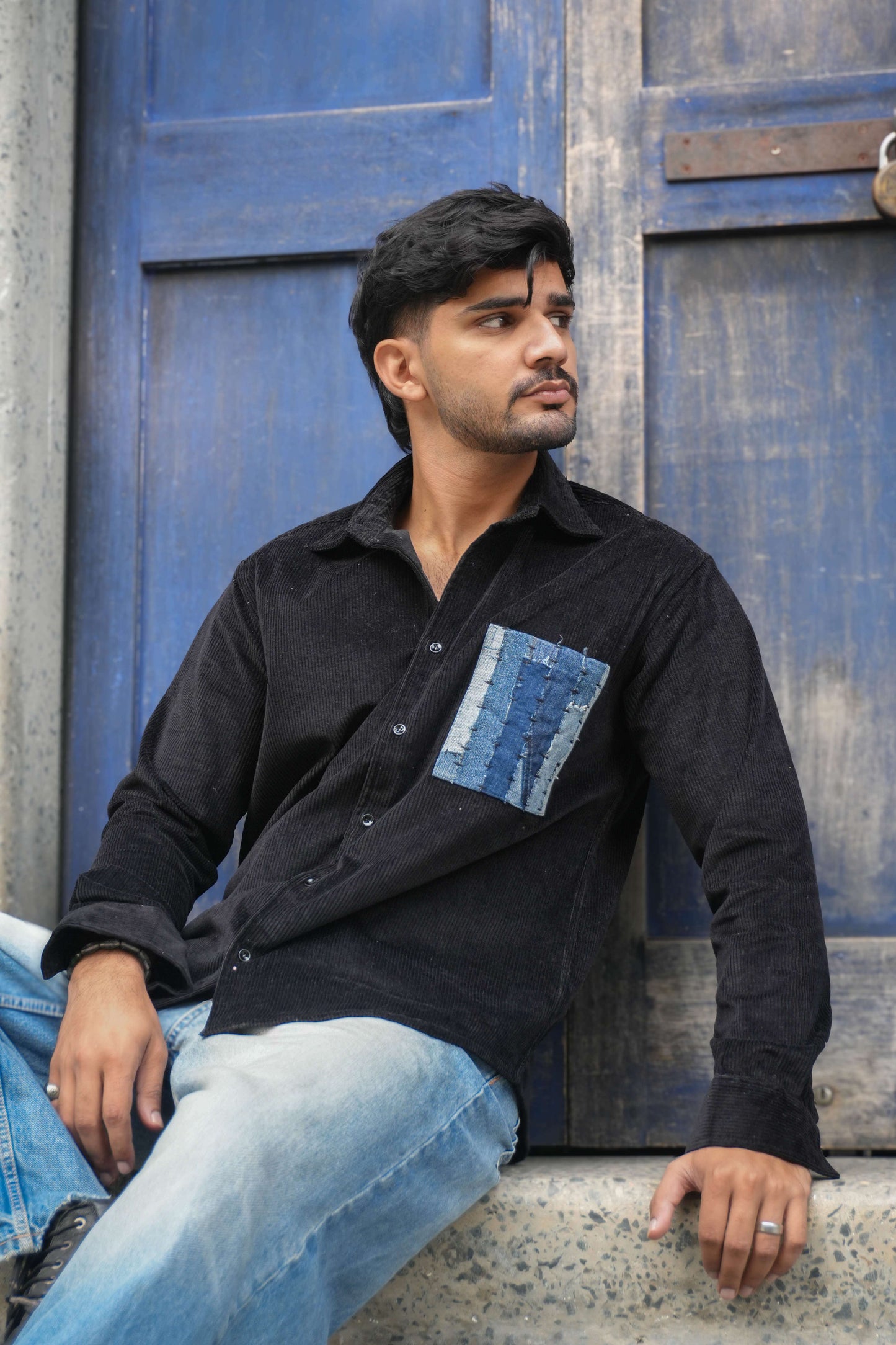 Black corduroy shirt for men with denim patchwork pocket, seated view, Leh Corduroy Shirt by Oje'