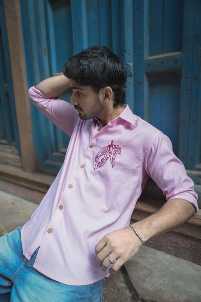 Blush pink cotton satin shirt for men with hand embroidered chilli motif, seated view, Mexico Embroidered Shirt by Oje'