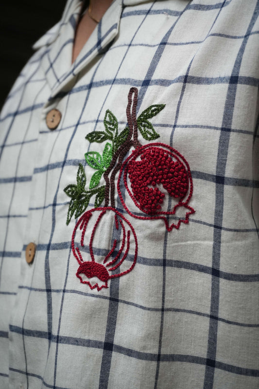 Close-up of the pomegranate embroidery in aari and French knots, White and blue checks cotton men's shirt