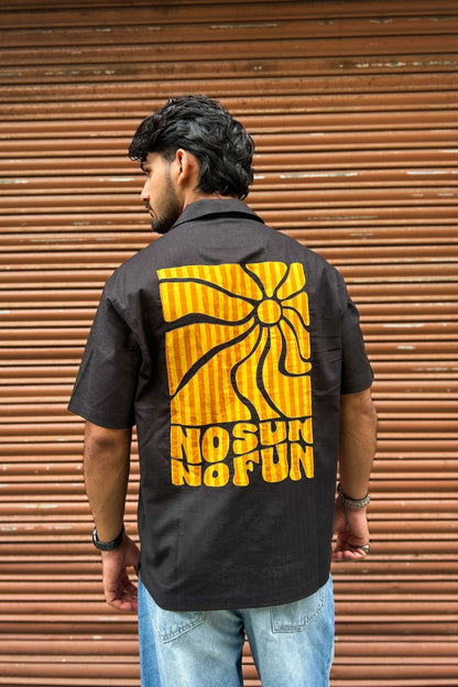 Back view of black cotton men's shirt with appliquéd sun motif and No Sun No Fun lettering