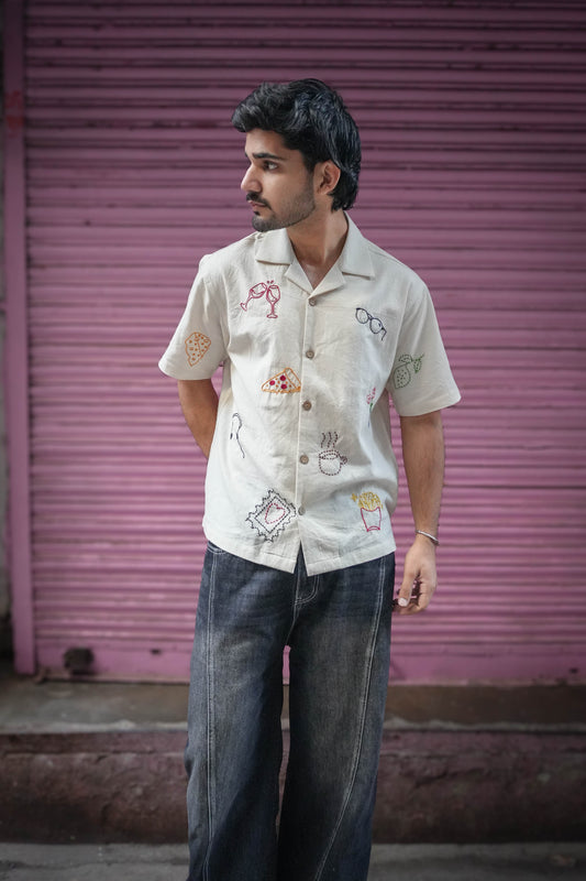 Ivory handloom cotton shirt for men with hand embroidered vacation motifs, full-length view