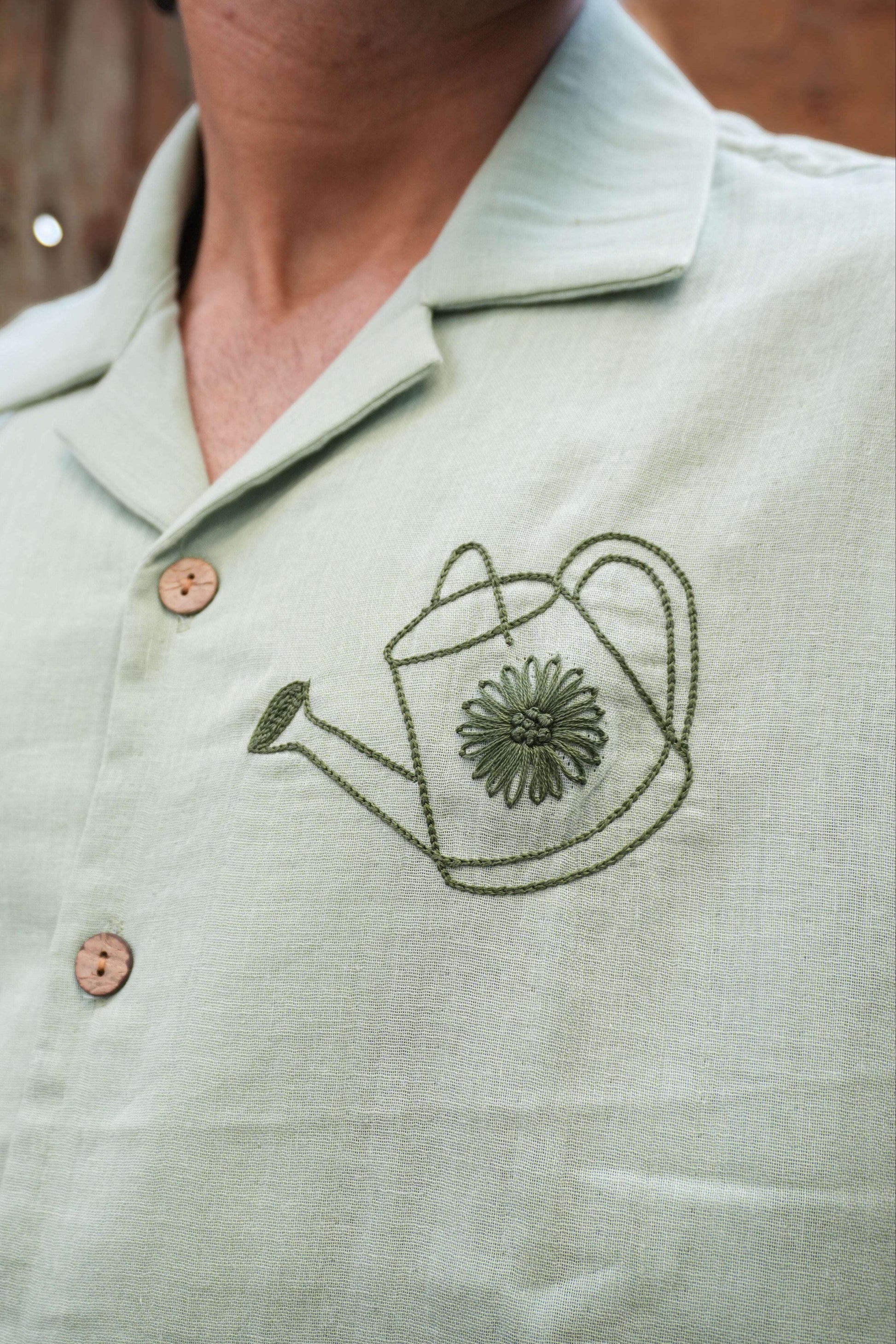 Close-up of the watering can motif on the chest, Sage green double cloth cotton men's shirt