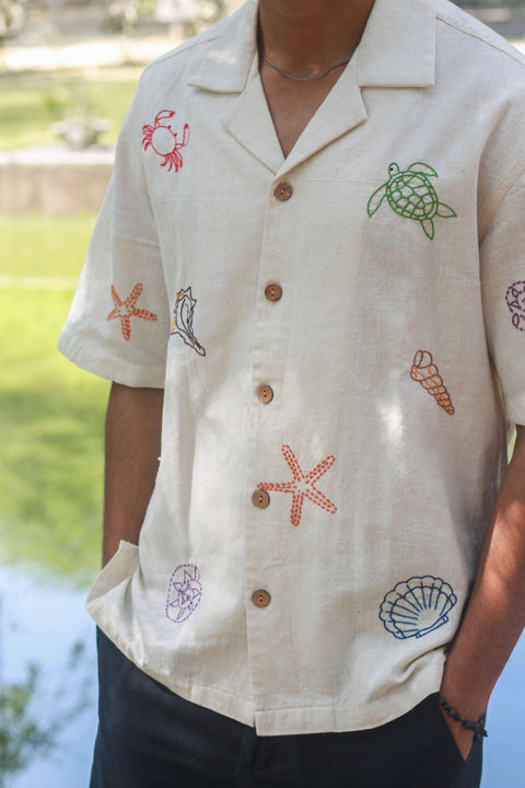 Close-up of the kantha turtle, starfish and shell motifs, Ivory handloom cotton men's shirt