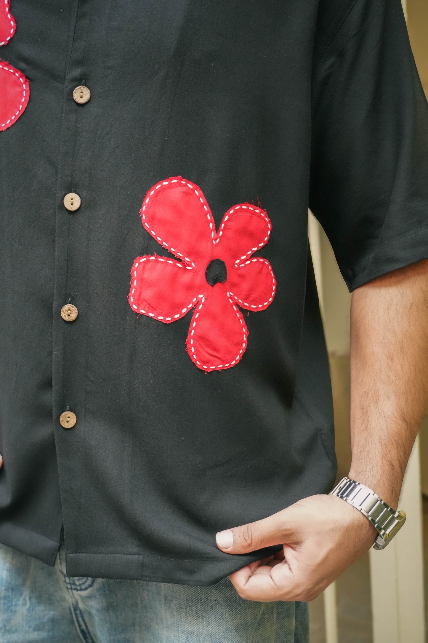 Close-up of the floral appliqué near the hem, Black modal viscose men's shirt