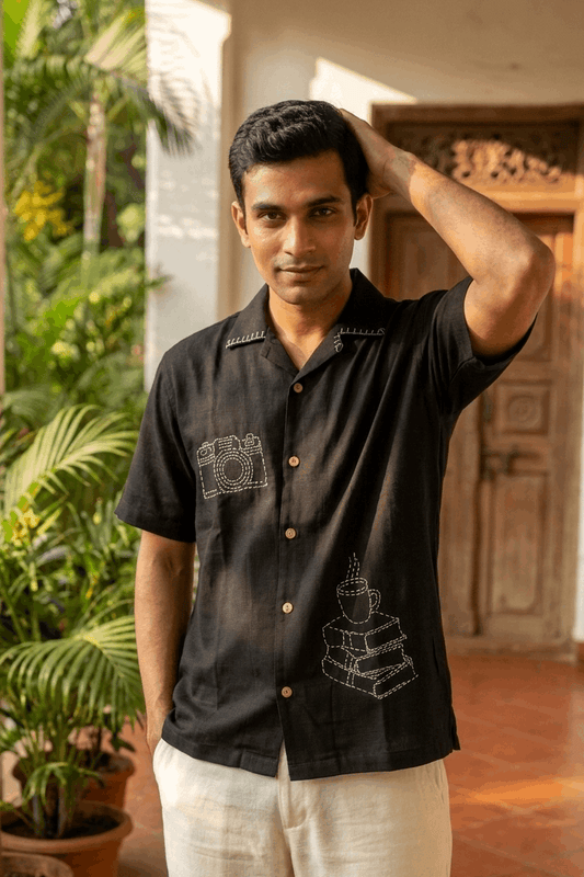 Man wearing black hand embroidered modal shirt outdoors, front view