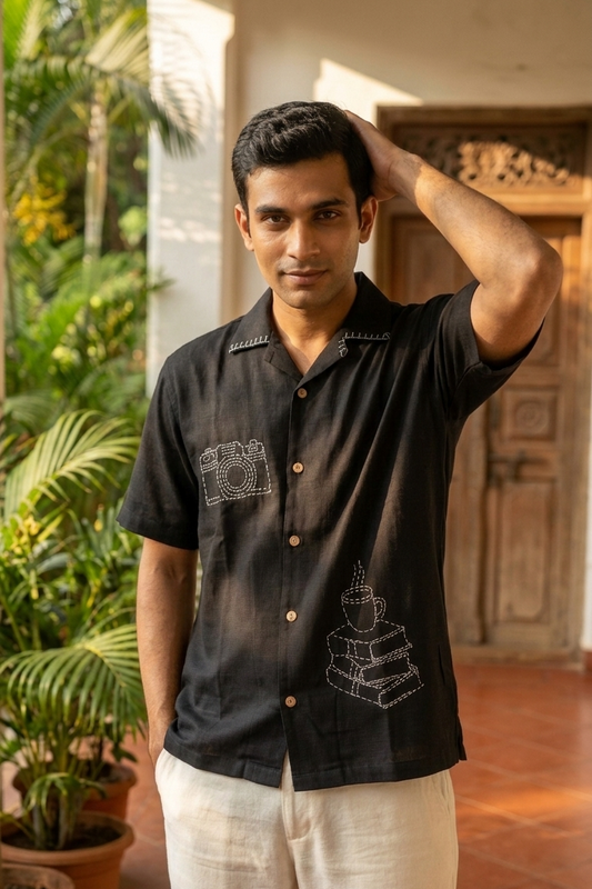 Man wearing black hand embroidered modal shirt outdoors, front view